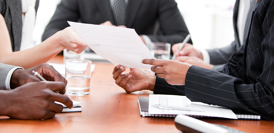 Business professionals engaged in discussions, highlighting the significance of understanding psychology in achieving successful business deals.