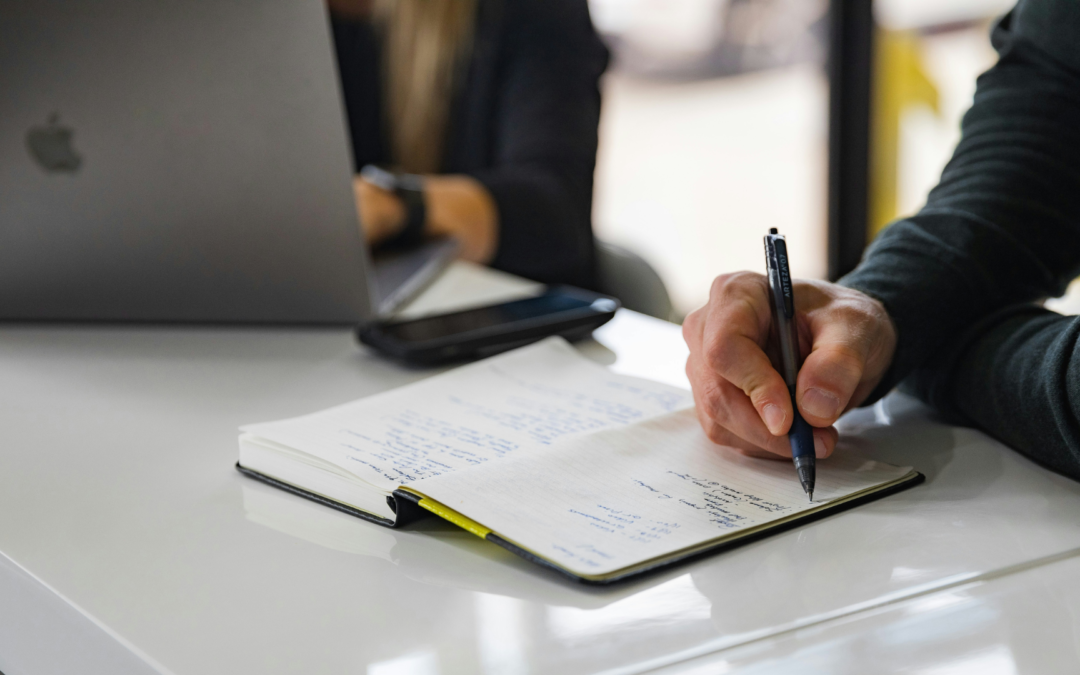 A business owner reviewing financial documents and market trends to determine the right time to sell.